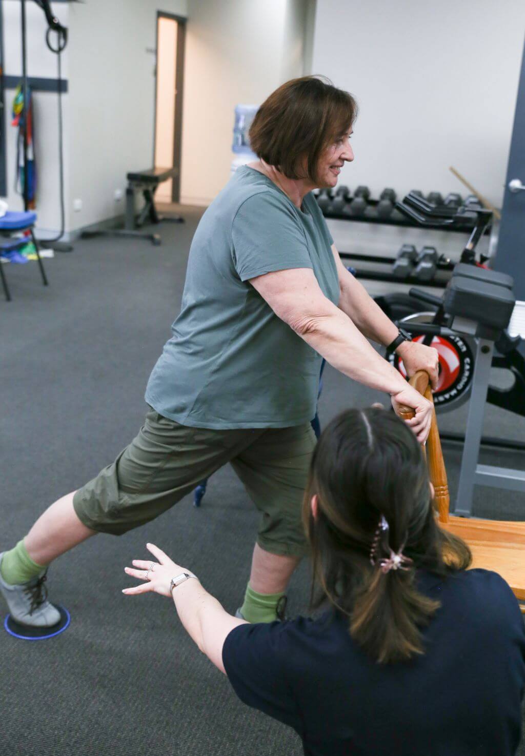 Physiotherapist assisting patient with an exercise