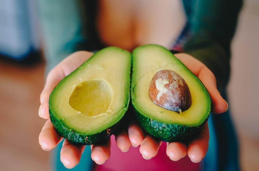 Dietitian holding an avocado to show healthy eating habits